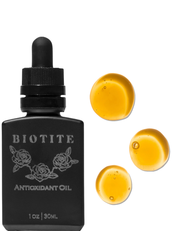 Biotite antioxidant oil bottle with dropper and yellow oil droplets on a white background